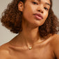 SOPHIA heart pendant necklace gold-plated on a woman's neck, featuring a velvet-matt heart and a smaller crystal-dusted heart, highlighting the Pilgrim style.