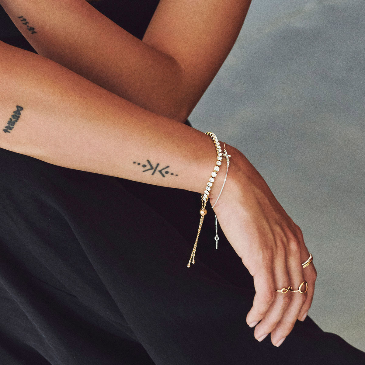 LUCIA crystal bracelet gold-plated on tattooed wrist, showcasing sparkling crystals and elegant design with modern adjustable closure, embodying Pilgrim's timeless and trendy jewellery style.