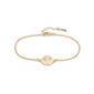 ELIN coin bracelet in gold-plated finish, featuring a slender chain and a circle with an etched tree motif, embodying Scandinavian elegance.