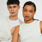 Two young models wearing CLARA crystal cross necklace silver-plated, showcasing its sparkling crystals and modern design against a light background.