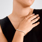 Close-up of a woman's hand on her collarbone, showcasing the LUCIA silver-plated tennis bracelet with sparkling Preciosa crystals, highlighting its chic and timeless elegance.