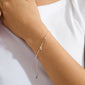 ANET crystal bracelet silver-plated with dangling charms: anchor, heart, and cross adorned with Preciosa crystals, elegantly displayed on a wrist wearing a rib-knit tank top.