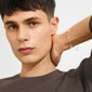Young man wearing ANET crystal bracelet silver-plated, featuring faith, hope, and love pendants with Preciosa crystals, embodying Pilgrim's blend of timeless and trendy design.