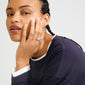 Close-up of a young woman showcasing the XENA ring, a silver-plated, ribbed statement piece on her hand, embodying Pilgrim's blend of timeless and trendy design.