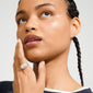 Young woman wearing the XENA ring, a silver-plated, chunky statement piece with a fluted surface, gently resting her chin on her hand.