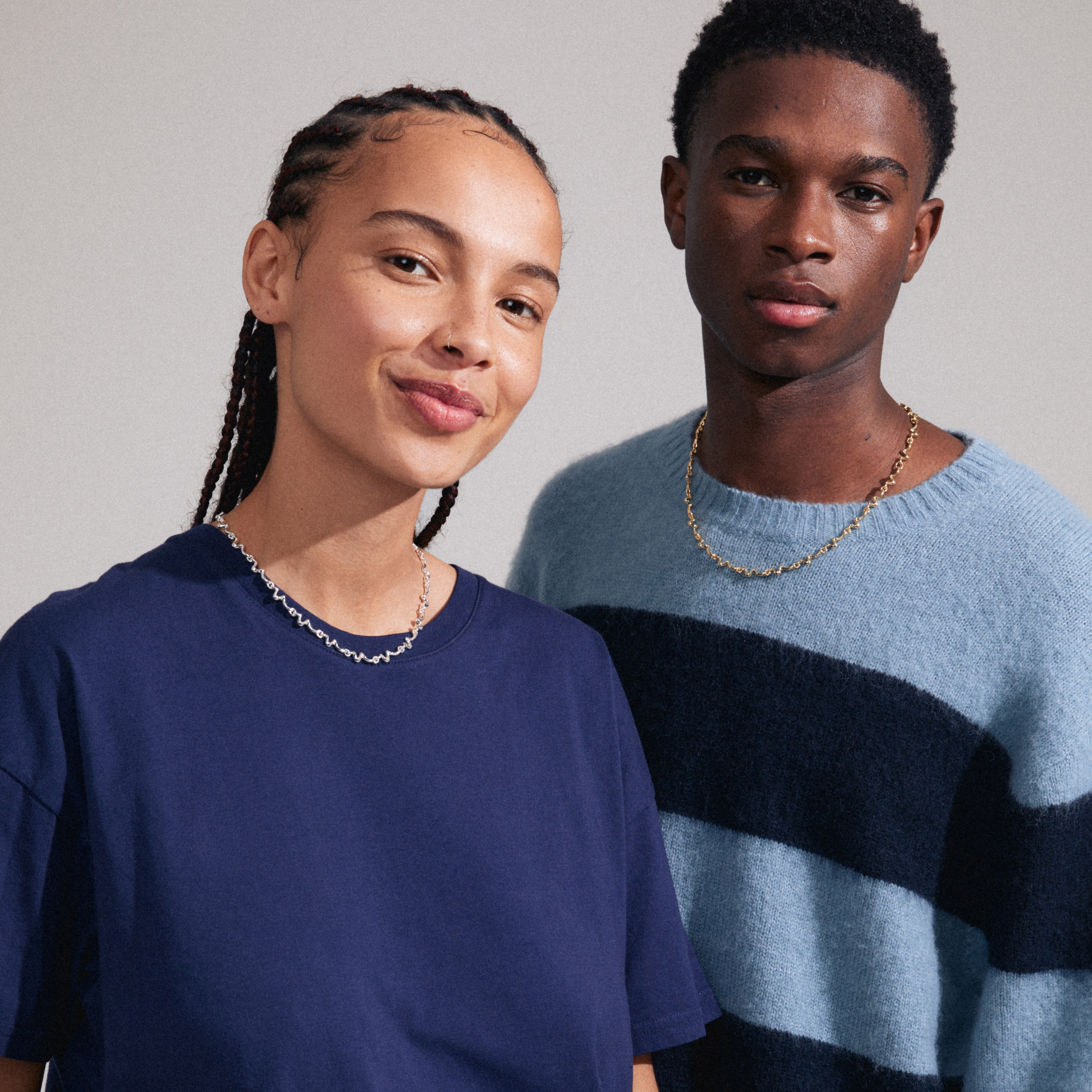 PENELOPE necklace silver-plated featuring a wavy, graphic design on a woman's neck, highlighting its stylish and timeless aesthetic.