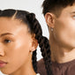 Two individuals in profile wear AVA star hoop earrings, silver-plated with tiny star charms, showcasing Pilgrim's blend of timeless and trendy Danish design.