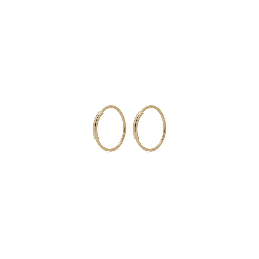 RAQUEL x-small gold-plated hoop earrings with an intriguing extra detail on the outer ring, perfect for versatile styling and modern elegance.