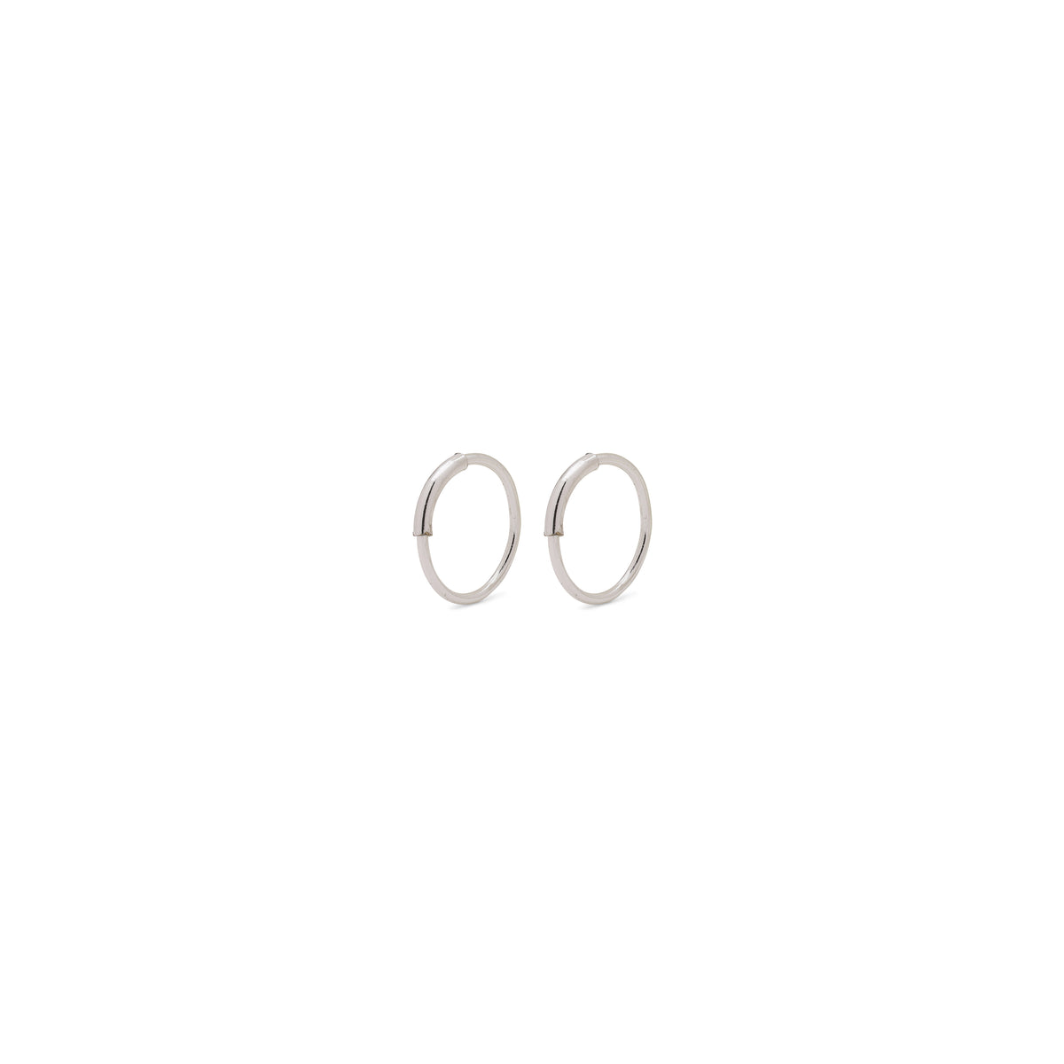 RAQUEL mini hoop earrings, silver-plated, featuring minimalist design with an intriguing outer detail, perfect for versatile styling and appealing to trendsetters seeking timeless Danish craftsmanship.