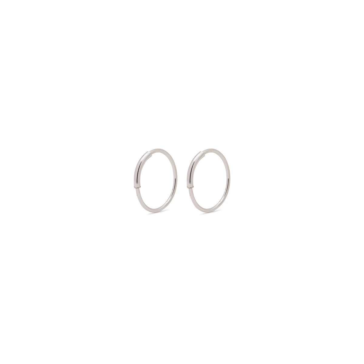 RAQUEL x-small silver-plated hoop earrings featuring minimalist design with an intriguing outer detail, ideal for versatile styling.