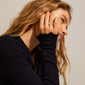 Woman wearing the BATHILDA rustic ring, silver-plated, showcasing its minimalist and chunky design on her hand, embodying bold elegance for versatile style.