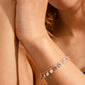 Silver-plated CAROL bracelet featuring intricate filigree coins and crystals, worn by a woman, capturing the essence of Pilgrim's travel-inspired, timeless jewelry collection.