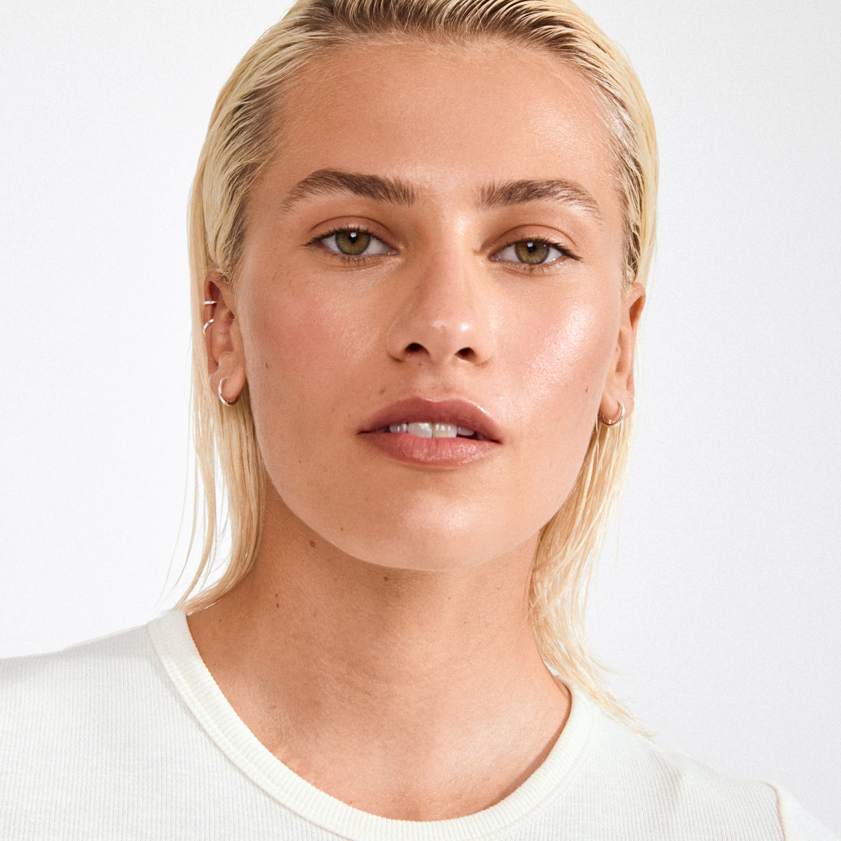 Young person wearing Pilgrim's ARIELLA silver-plated 2-in-1 hoop earrings, showcasing their glossy finish and chunky design, perfect for everyday style.