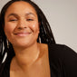 BERTHE pearl chain earrings, gold-plated, featuring organic shapes and white freshwater pearls, worn by a smiling woman.