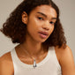 Woman wearing ALMA necklace silver-plated with teardrop pendant, showcasing its Scandinavian design and adjustable chain for a stylish, feminine look.