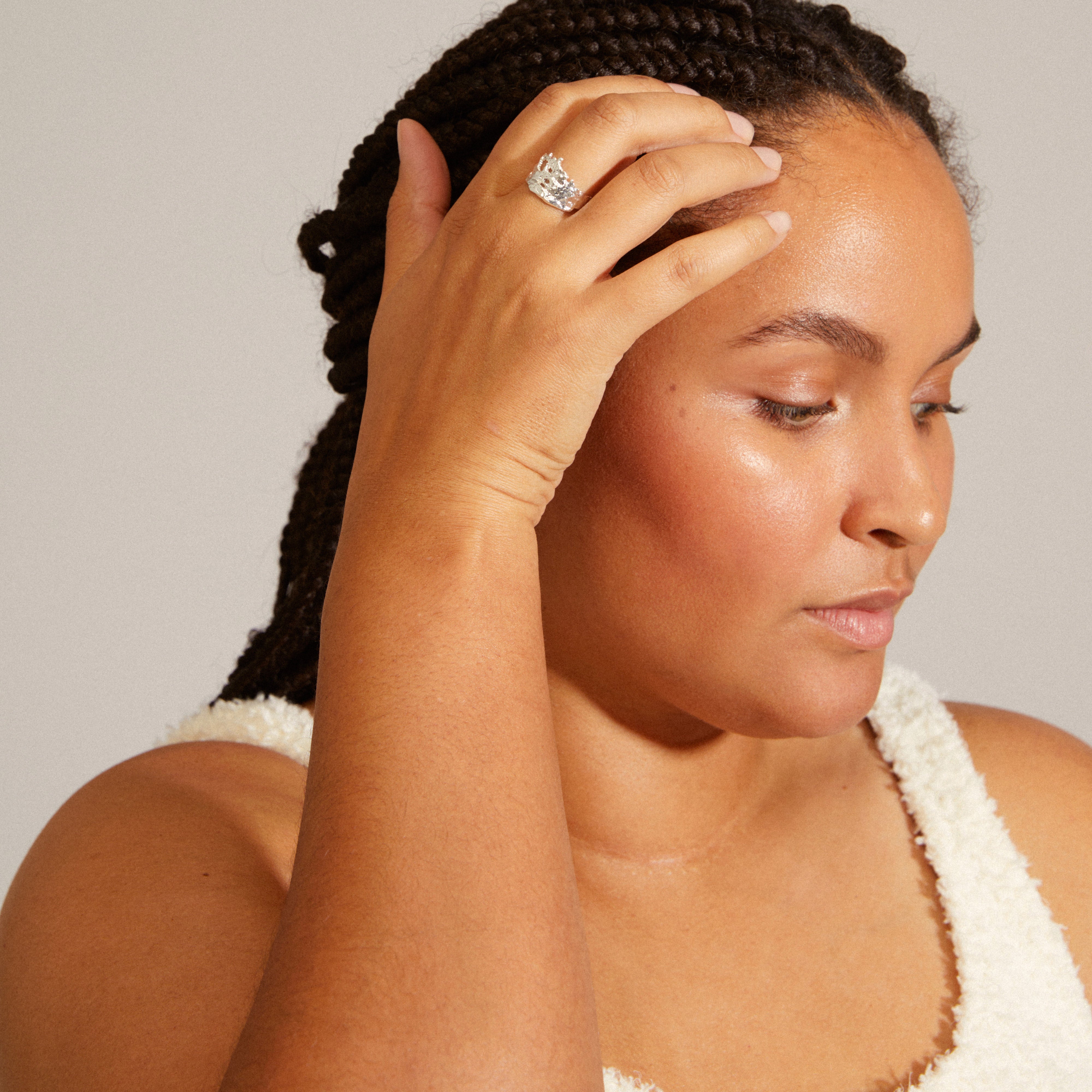 Woman's hand showcasing the BRENDA ring, a silver-plated, wavy, recycled accessory from Pilgrim, emphasizing its handcrafted, upscale rustic design.
