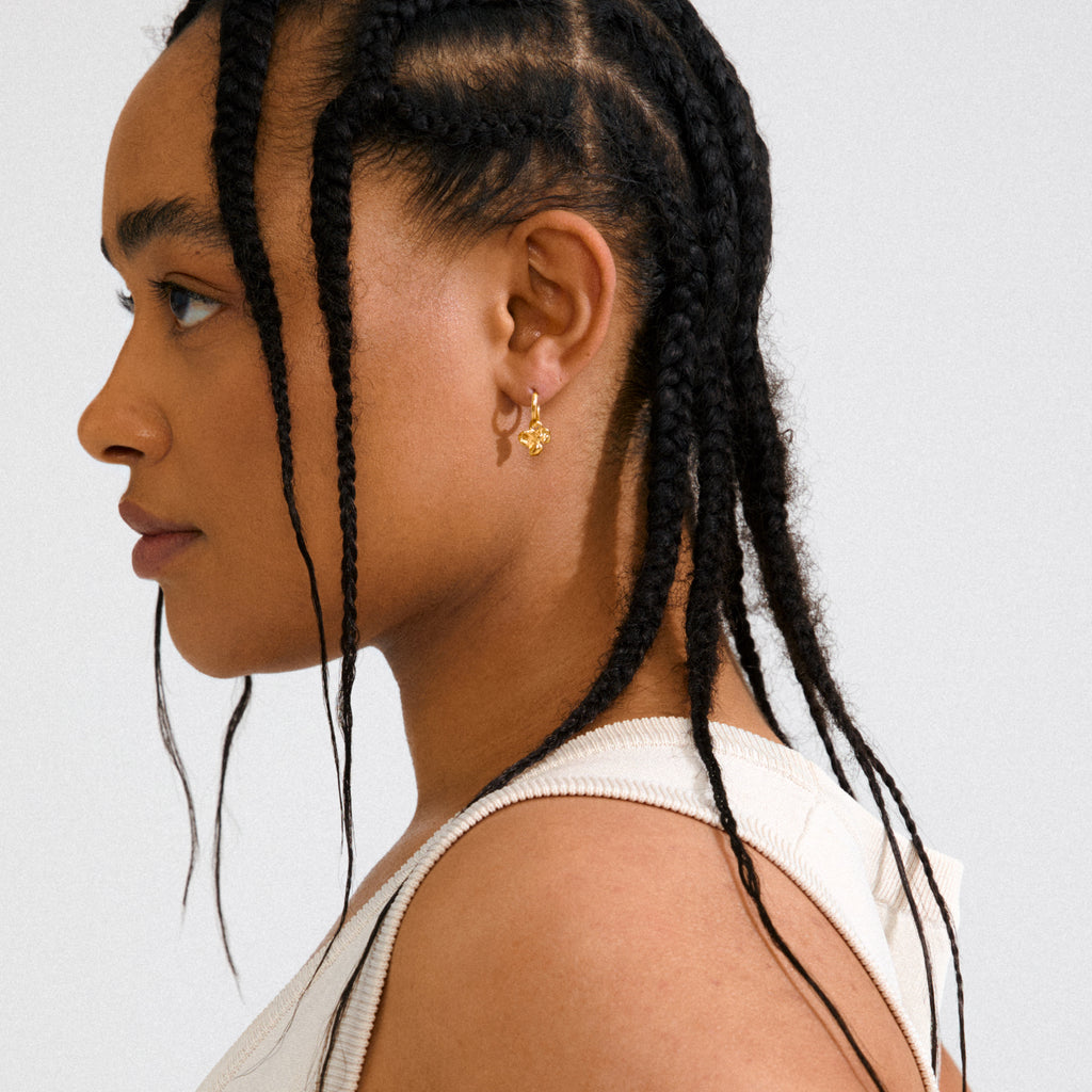 Gold-plated LUIS earrings with abstract flower pendants, featuring versatile click clasps, offering a boho luxe vibe or minimalist style, crafted from 99% recycled materials.