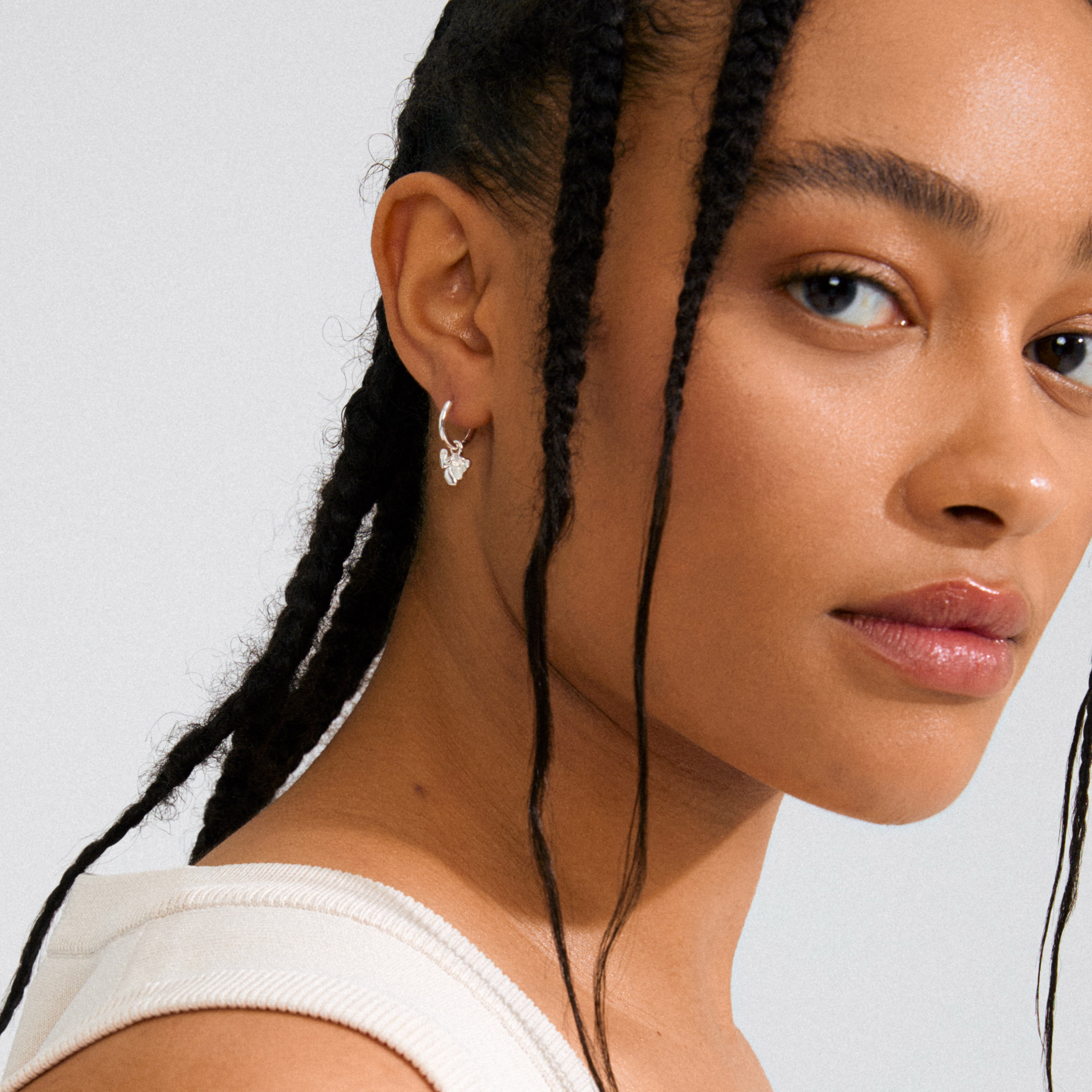 Silver-plated LUIS earrings featuring detachable abstract flower pendants, offering versatile styling options for both boho and minimalist looks. Made from 99% recycled material.
