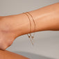 PALLAS anklet gold-plated on a person's ankle, showcasing its delicate design and adjustable fit. Perfect for complementing stylish footwear at festive or summer events.