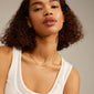 NANCY necklace 45 cm gold-plated on a woman with curly hair wearing a white tank top, highlighting its versatility for layering or adding a pendant.
