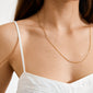 Close-up of a woman wearing the NANCY necklace, a 60 cm gold-plated Venezia chain, perfect for versatile styling with pendants or layering.