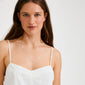 Young woman wearing the NANCY necklace, a 60 cm silver-plated Venezia chain, styled simply with a white spaghetti-strap top, reflecting Pilgrim's minimalist elegance.