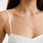 Close-up of a woman wearing the NANCY necklace 60 cm silver-plated, a delicate silver chain resting on her collarbone, perfect for layering or adding pendants.