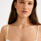 Young woman models the NANCY necklace, a 60 cm silver-plated Venezia chain, highlighting its simple elegance and versatility for layering or adding pendants.