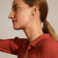 SANNE medium hoop earrings, silver-plated, showcased on a woman. These 26 mm hoops offer timeless elegance and versatility for everyday wear or personalized styling.