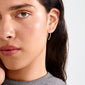 Young woman wearing SANNE medium hoop earrings, silver-plated, showcasing timeless elegance and everyday style with a close-up of her face and neck.