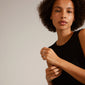 A woman wearing a black dress showcases the LULU stack ring, silver-plated, highlighting its elegant and sophisticated design from Pilgrim's stackable collection.