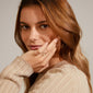 Close-up of a woman wearing the LULU stack ring silver-plated from Pilgrim, with her hand resting on her face, showcasing its elegant design.