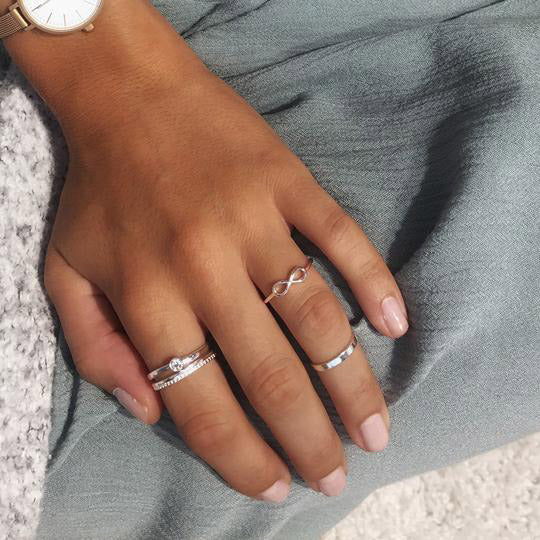 Silver-plated LULU eternity stack ring on a hand, showcasing Pilgrim's symbolic stackable ring collection, perfect for creating personalized, stylish combinations.