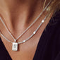 Silver-plated CAT necklace with textured, flattened links, worn by a woman. 50 cm chain with 9 cm extension, showcasing simple yet powerful design.