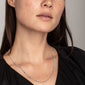Woman wearing the CAT necklace, silver-plated with flattened links, elegantly draped on the décolletage, showcasing Pilgrim's blend of timeless and trendy jewellery design.