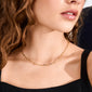Close-up of the RONJA necklace, a gold-plated, airy cable chain with sleek rectangular links, worn by a woman, showcasing its timeless, contemporary style.