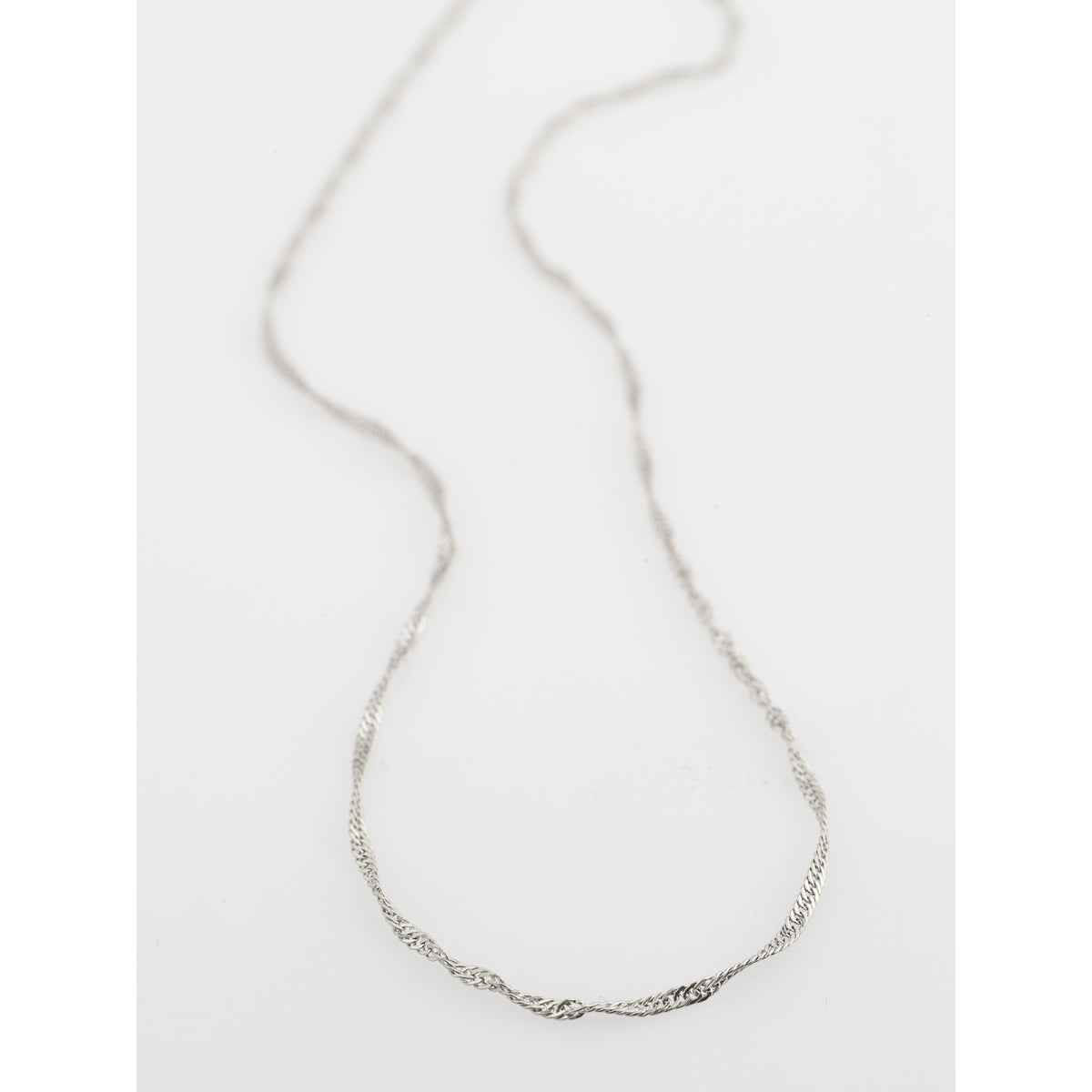 PERI twirl necklace, silver-plated, featuring a minimalist design with a pendant on a delicate chain, perfect for adding a feminine touch to any outfit.