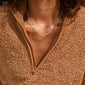 Close-up of a person wearing the RONJA necklace, silver-plated with paperclip links, resting at the collarbone, paired with a tan sherpa-style pullover.