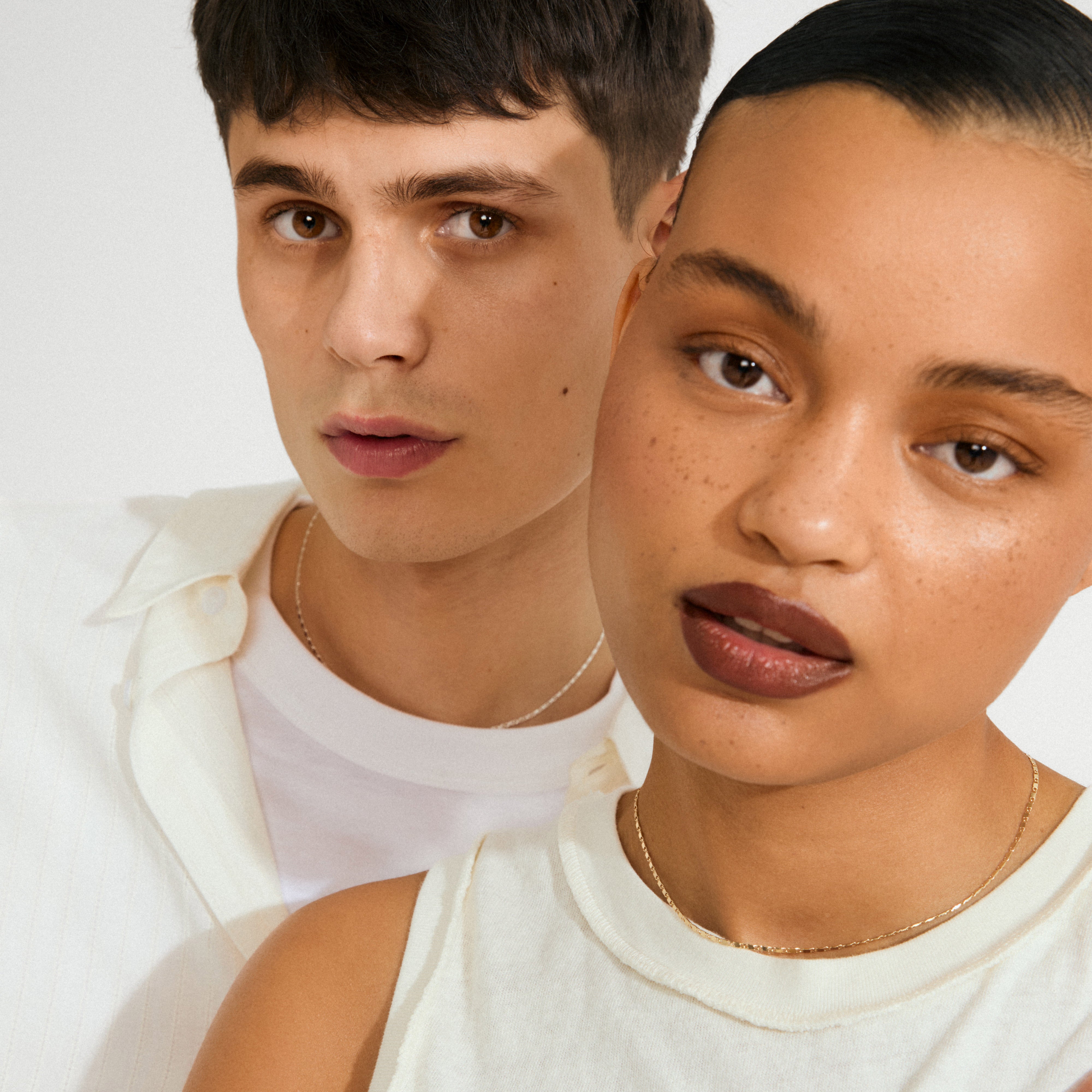 Young man and woman wearing the PARISA flat link chain necklace silver-plated, showcasing its reflective, polished design. Perfect for an effortlessly chic, layered look.