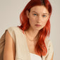 A woman with red hair wears the JOANNA flat snake chain necklace, gold-plated, highlighting its timeless elegance and Scandinavian craftsmanship from Pilgrim's Classics collection.