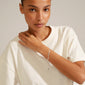 Woman wearing the JOANNA flat snake chain bracelet, silver-plated, featuring a classic design with an extension chain and Pilgrim tag.