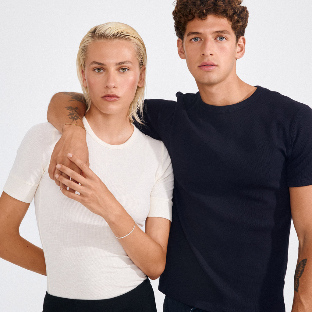 Two young adults showcasing Pilgrim's JOANNA silver-plated flat snake chain bracelet, highlighting its sleek, minimalist design on the left person's wrist.