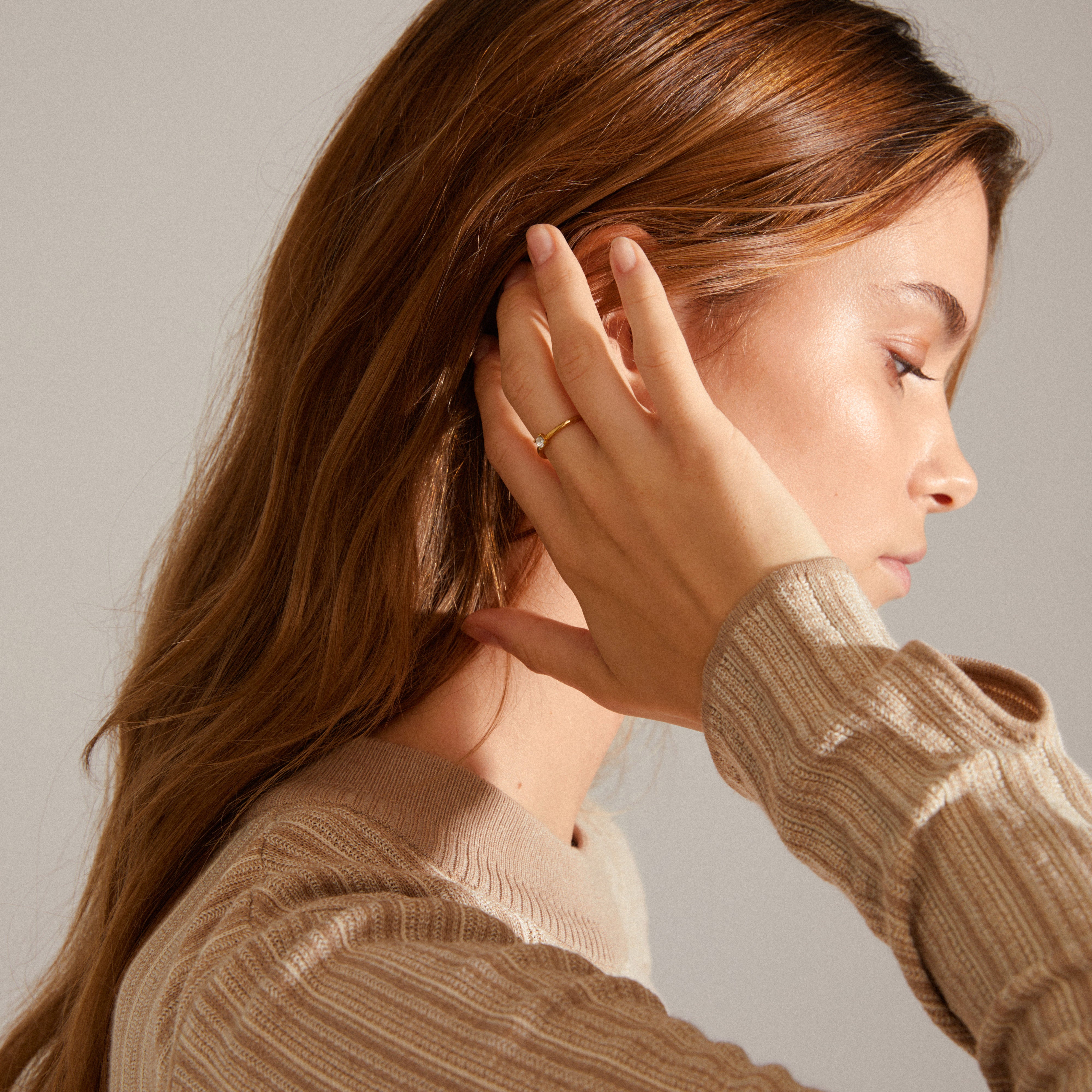 Woman wearing LULU crystal stack ring gold-plated, featuring a sparkling Preciosa crystal, perfect for stacking with other Pilgrim jewelry for a sophisticated look.