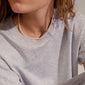 BAKER necklace 3-in-1 set silver-plated worn by a woman, showcasing three layered chains with pearls and trendy designs, perfect for versatile styling.