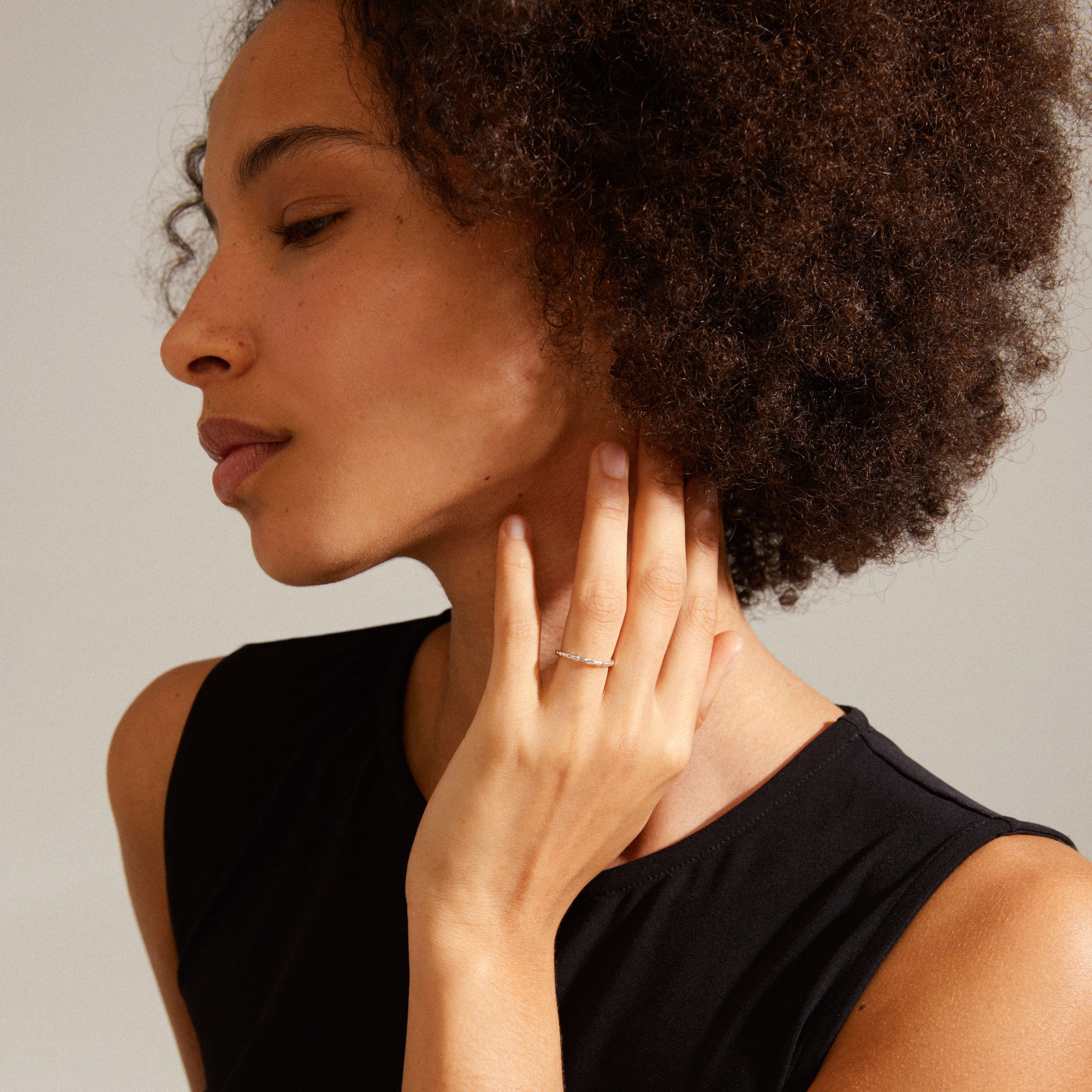 LULU stack ring silver-plated on woman's finger, showcasing its light, organic shape ideal for personalized, creative stacking.