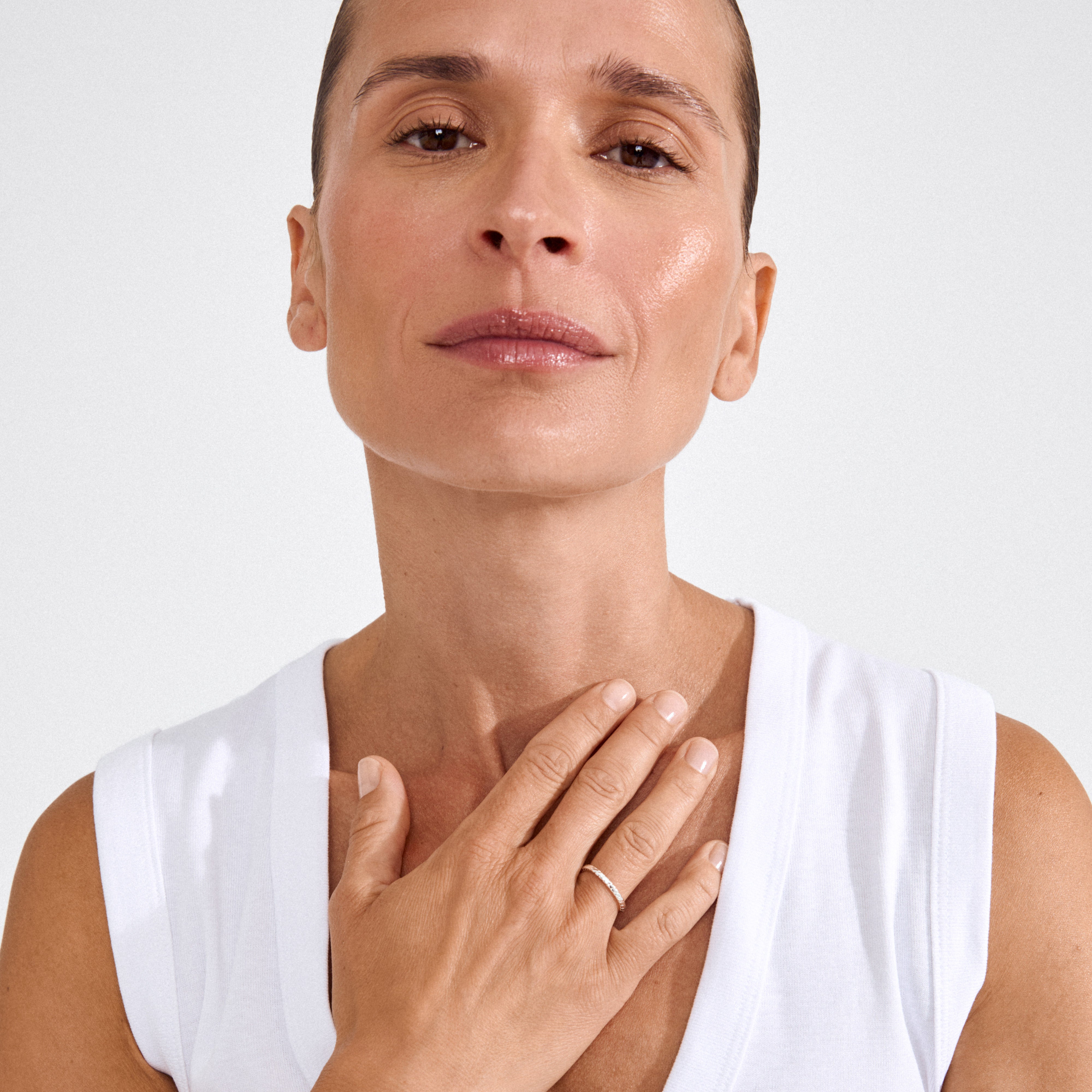 Close-up of a person wearing the silver-plated LULU twisted stack ring on their hand, highlighting its minimalist and timeless design.