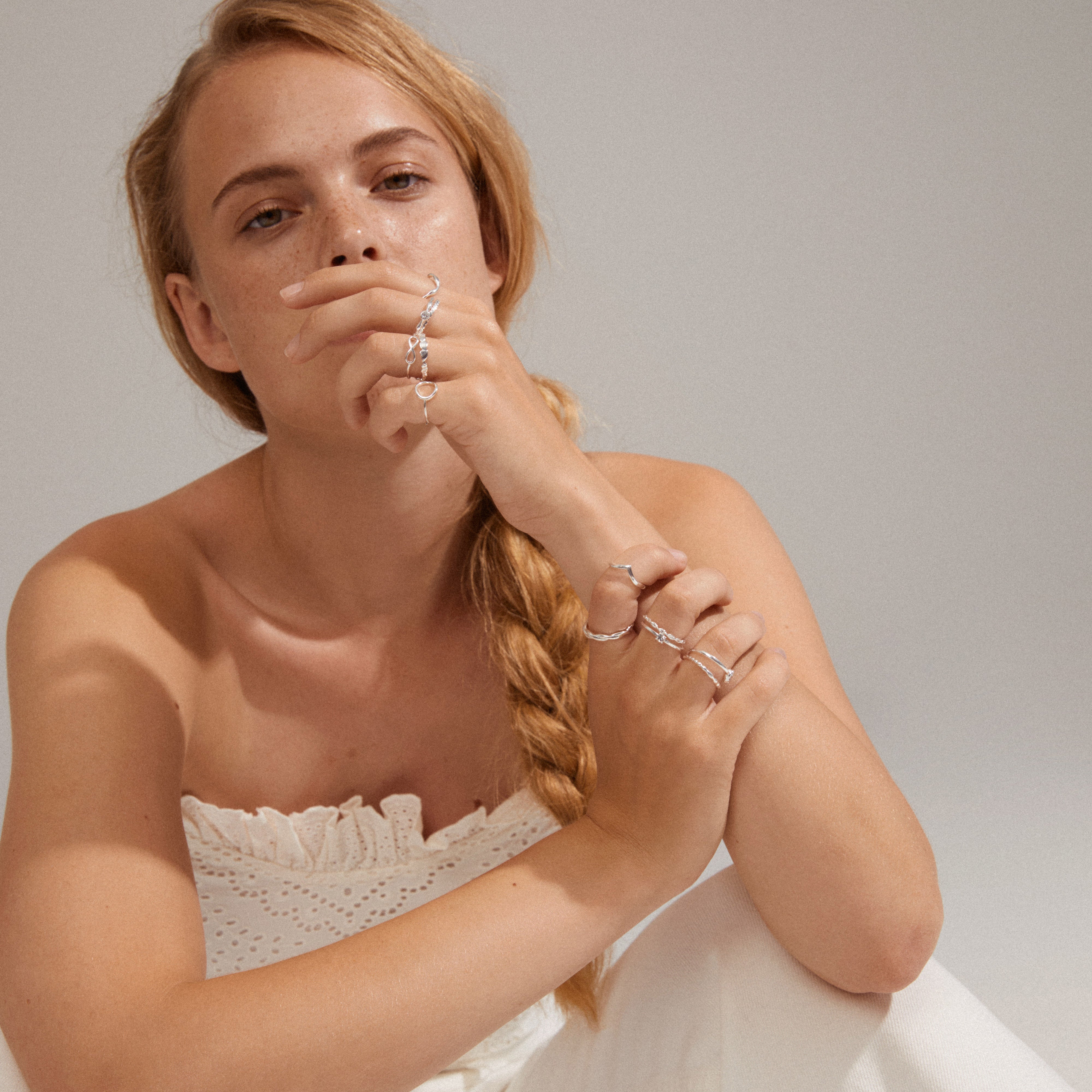 Woman wearing a silver-plated LULU stack ring from Pilgrim, showcasing its organic, playful shapes ideal for stacking with other rings.