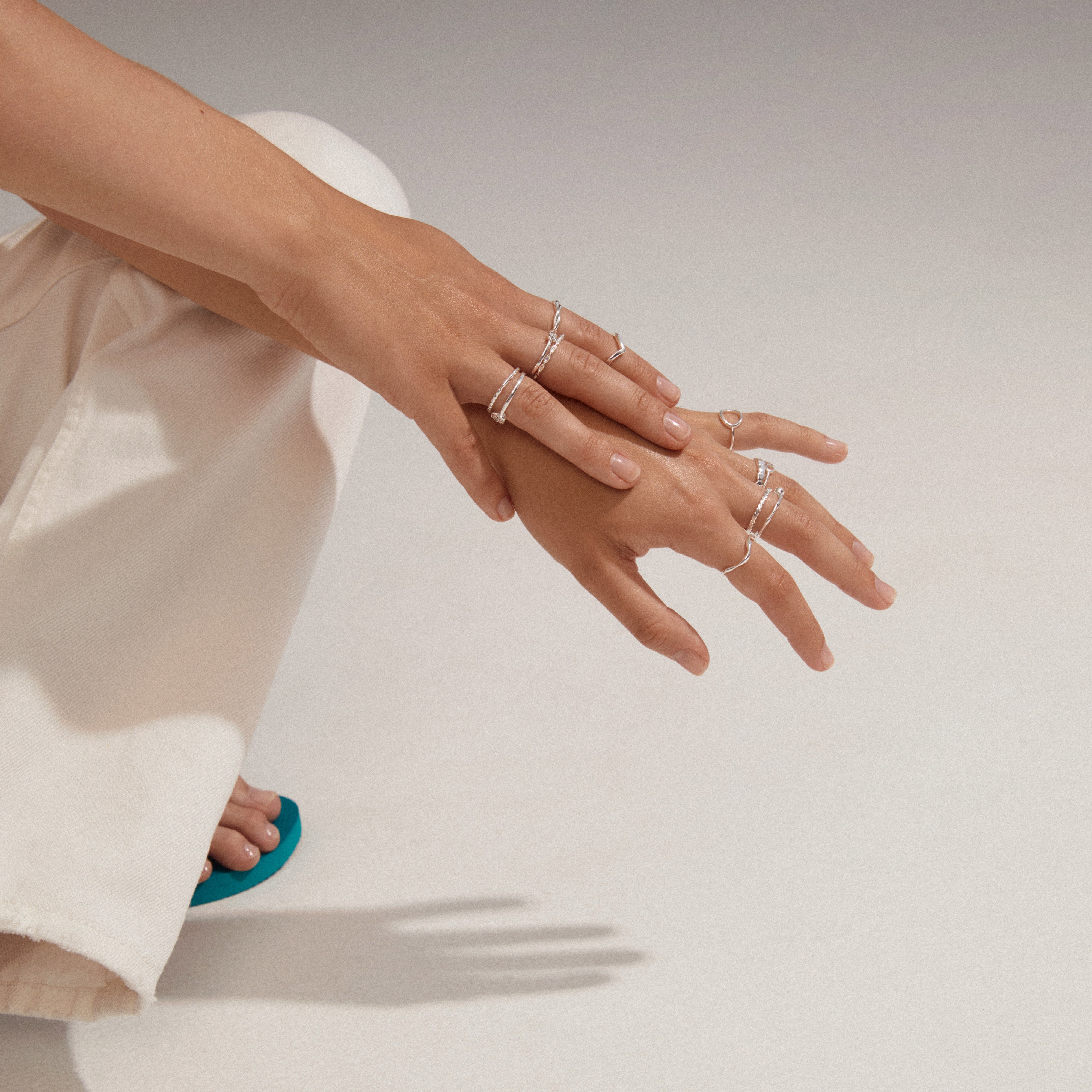 Close-up of hands wearing the LULU crystal heart stack ring, silver-plated, from Pilgrim's Lulu collection, showcasing its elegant design and Preciosa crystal details.