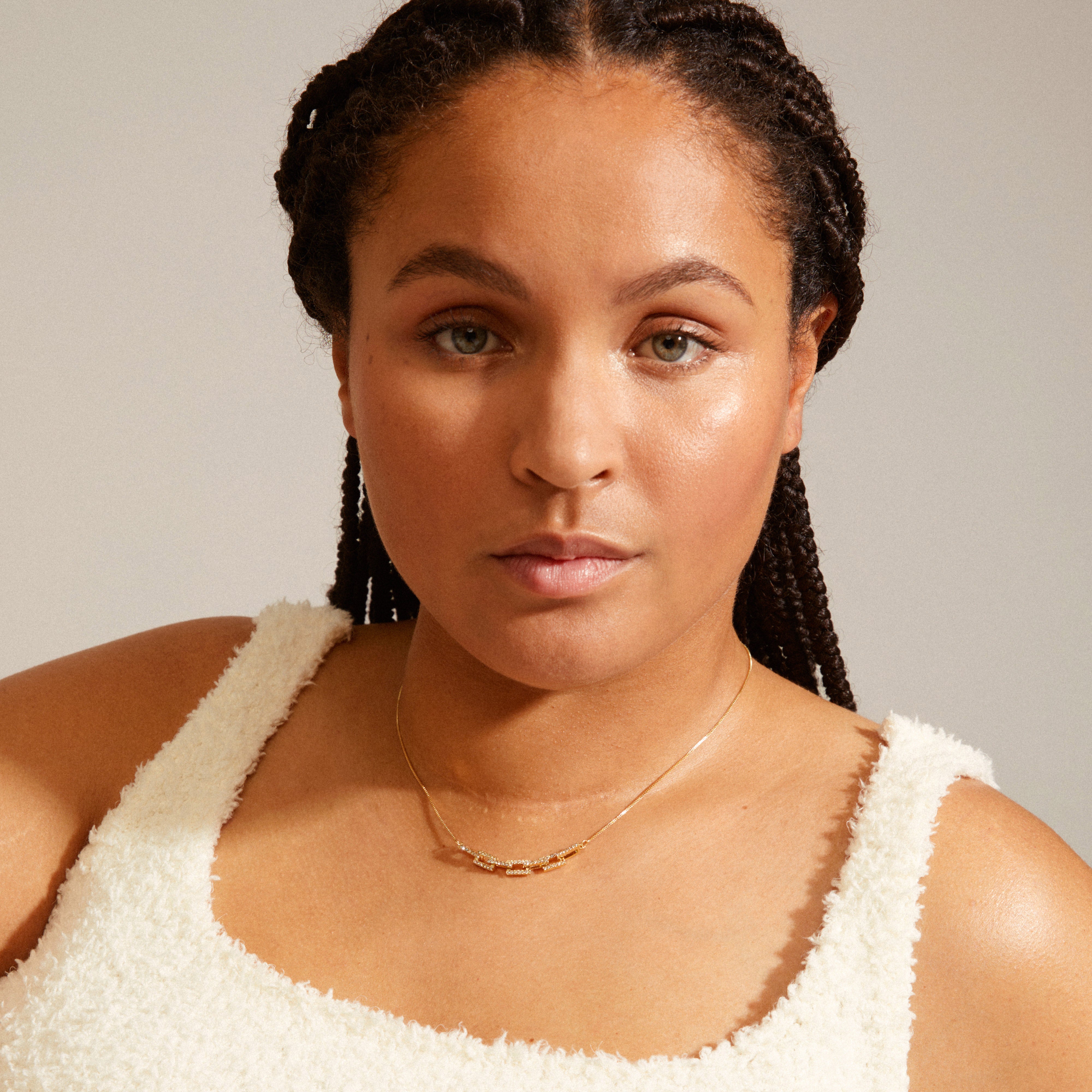 COBY crystal pendant necklace gold-plated showcased on a woman with braids, highlighting its rectangular links studded with Preciosa crystals for a sparkling look.