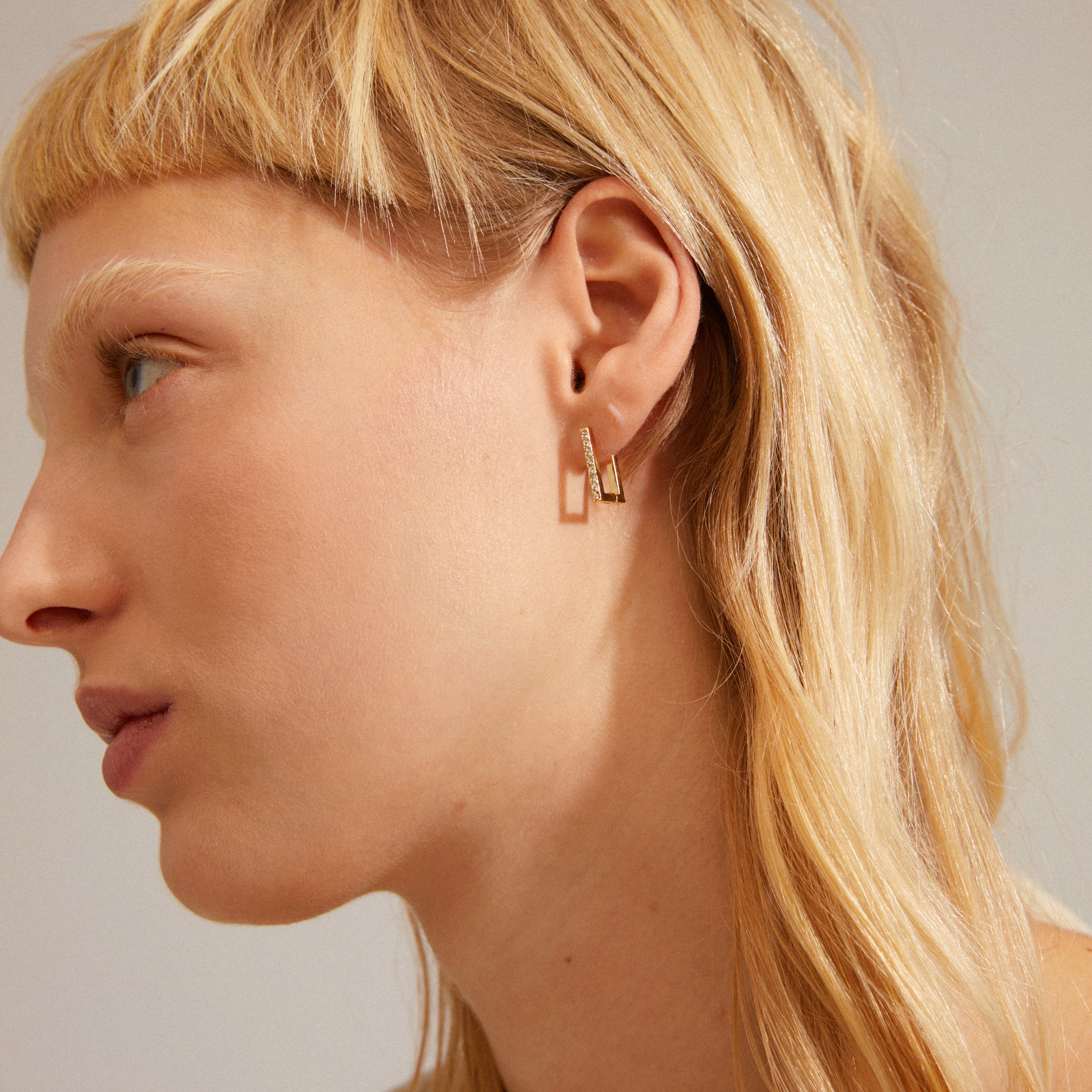 COBY crystal square hoop earrings gold-plated with sparkling Preciosa crystals, worn by a woman with blonde hair, showcasing elegant shine and classic design.
